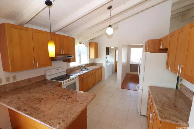 a kitchen with stainless steel appliances granite countertop sink stove and refrigerator