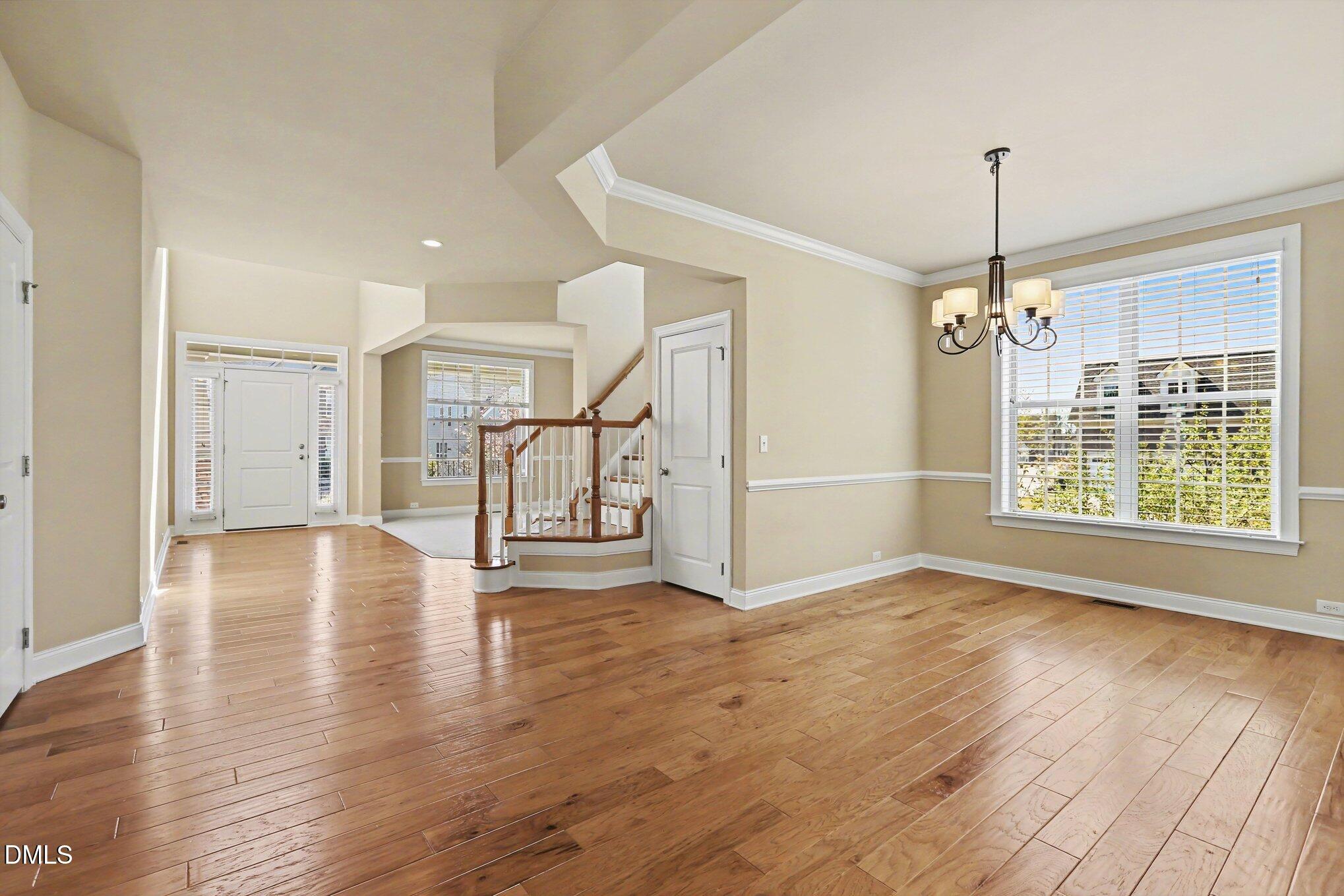 351 Gartrell Way Cary, NC 27519 - Photo 8 of 51 a view of an empty room with wooden floor fireplace and a window