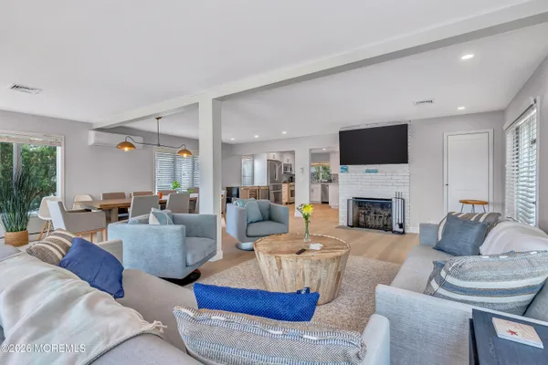 a living room with fireplace furniture and a flat screen tv