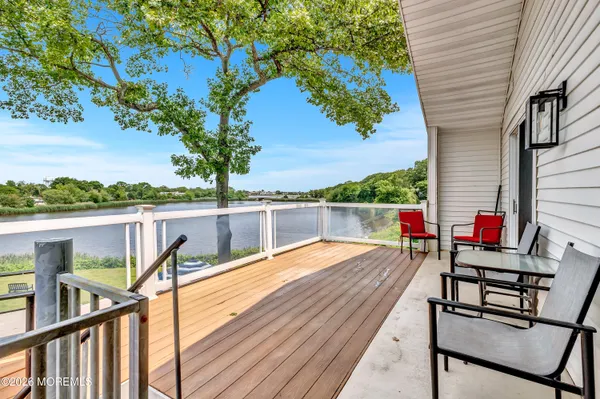 a view of deck with chairs and wooden fence