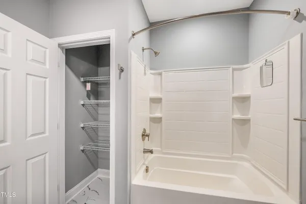a bathroom with a bathtub and shower