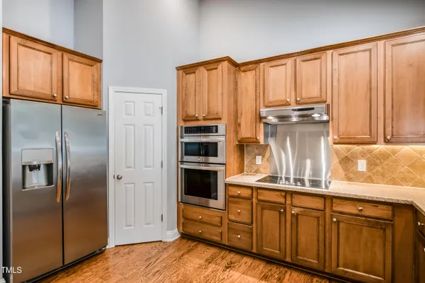 a kitchen with appliances cabinets and a window