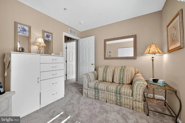 a living room with furniture and painting on the wall