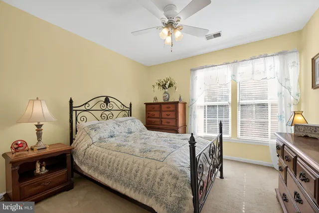 a bedroom with a bed a chandelier and a window