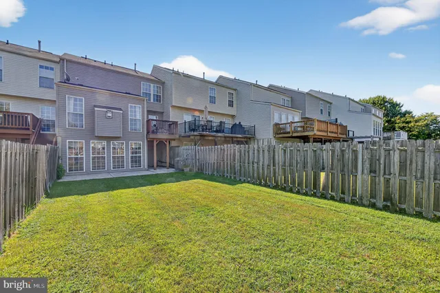 a view of a backyard with wooden fence