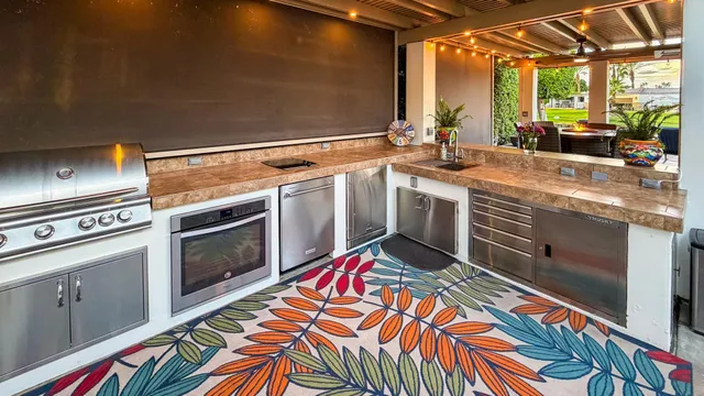 a kitchen with stainless steel appliances granite countertop a sink and a stove