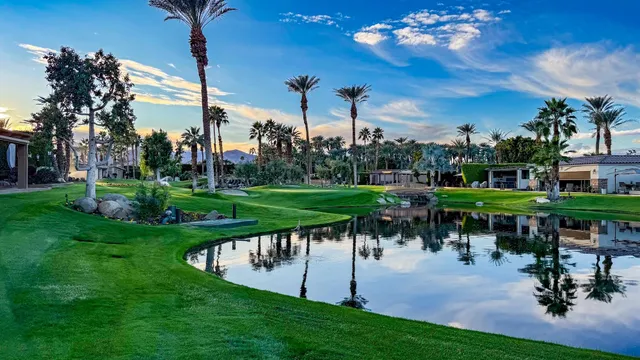 a lake view with a sitting space and a garden
