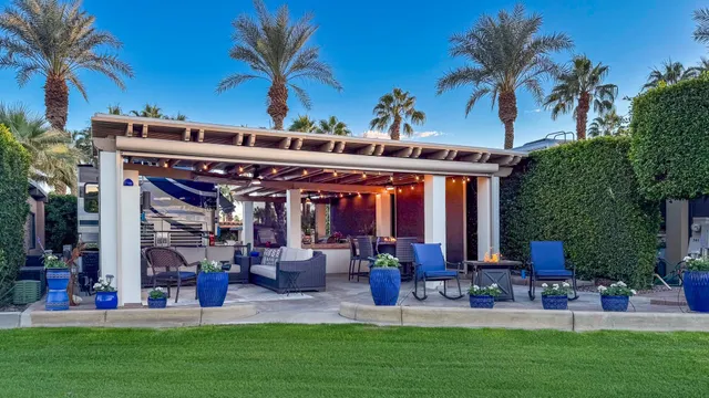 a view of a chairs and table in a big yard