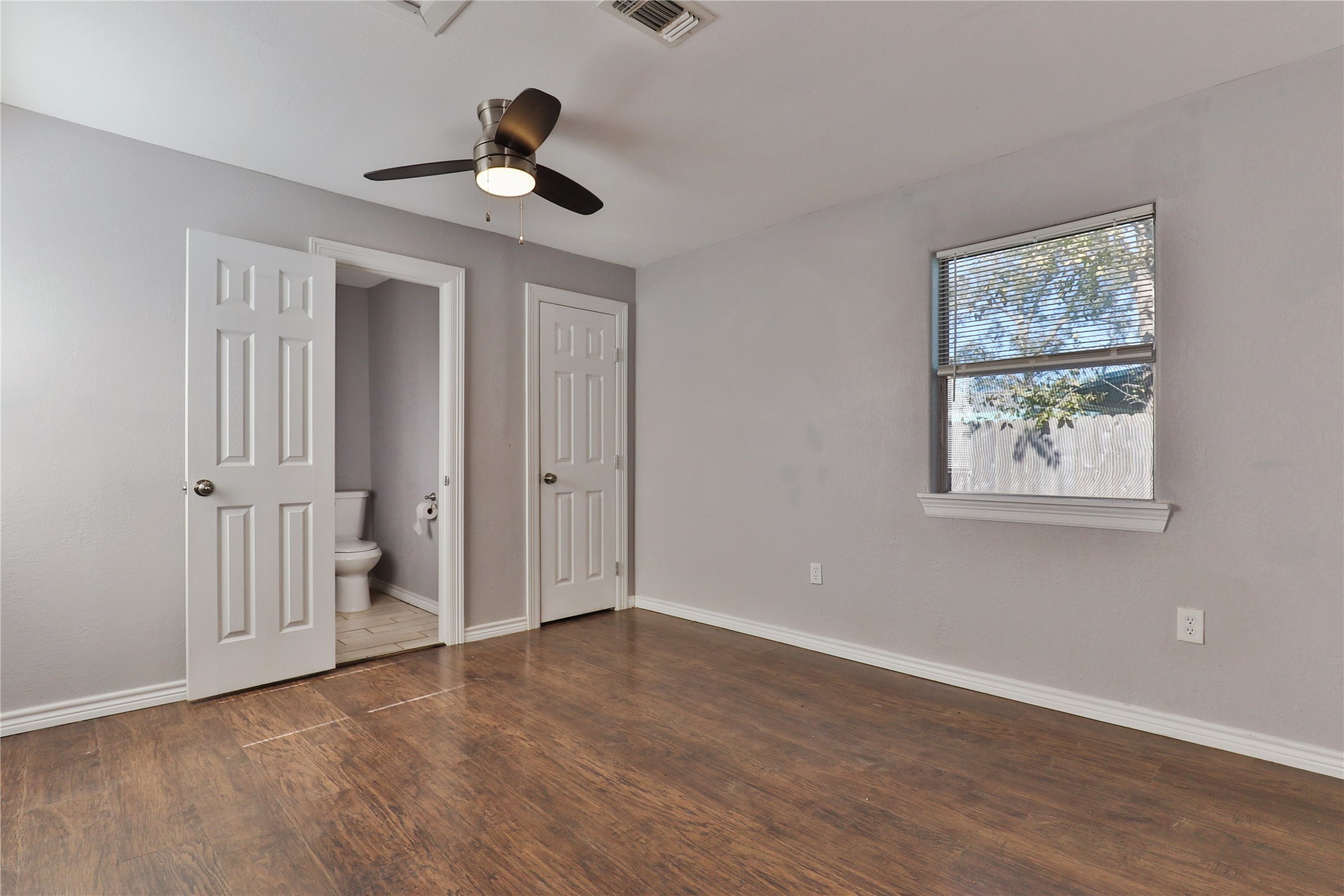 218 3 Rd Street Brazoria, TX 77422 - Photo 11 of 19 a view of an empty room with wooden floor and a ceiling fan