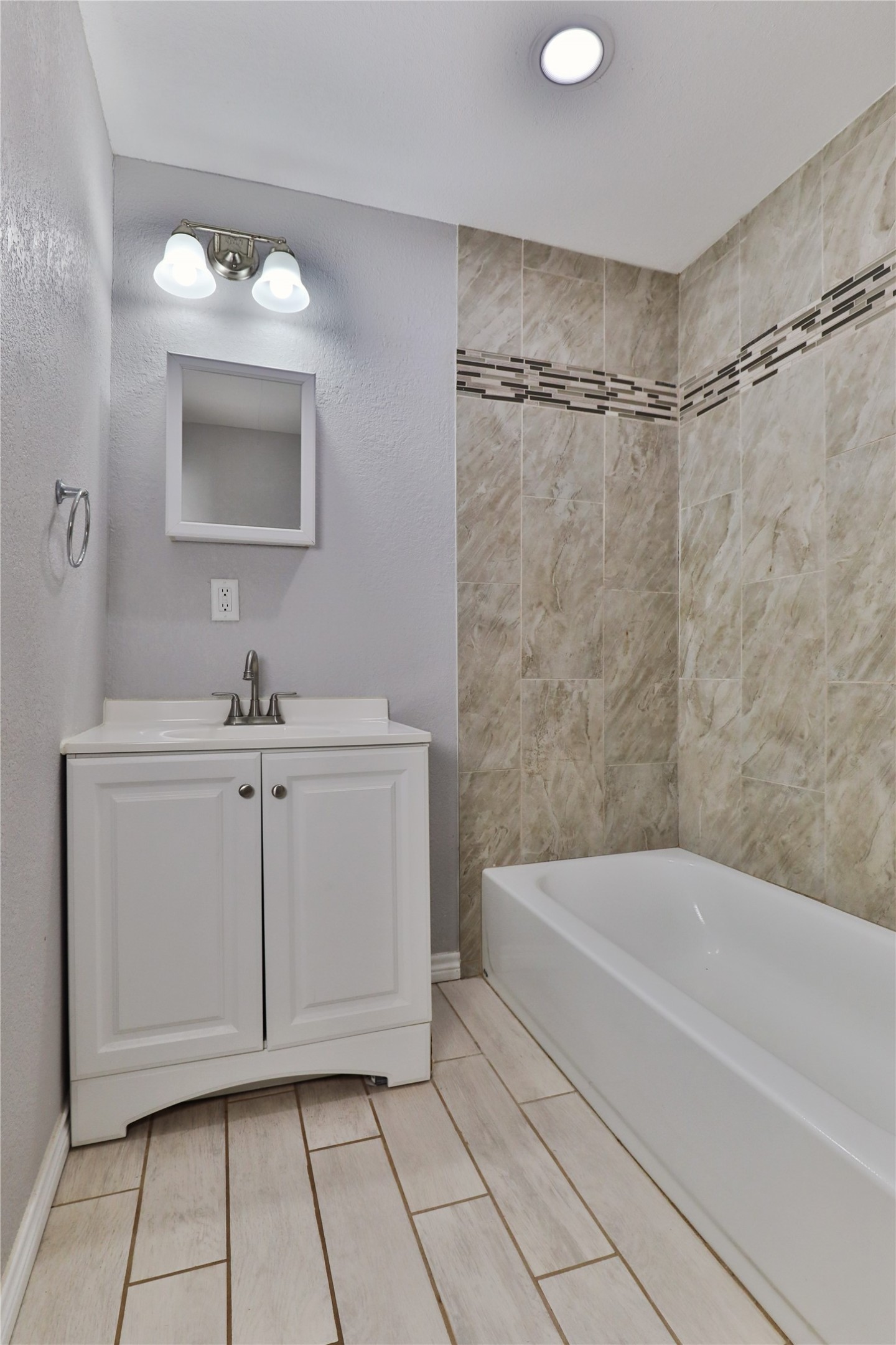 218 3 Rd Street Brazoria, TX 77422 - Photo 12 of 19 a bathroom with a bathtub a sink and a mirror