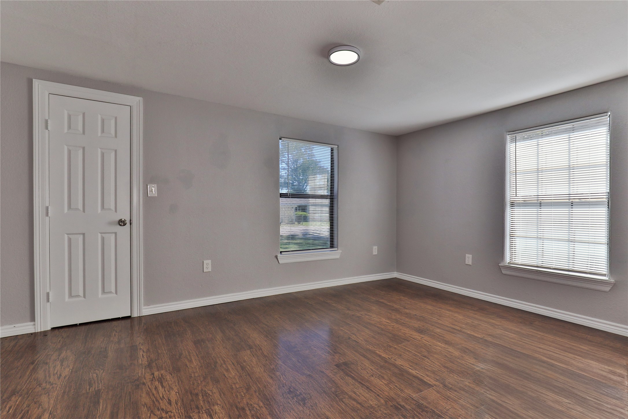 218 3 Rd Street Brazoria, TX 77422 - Photo 13 of 19 an empty room with wooden floor and windows