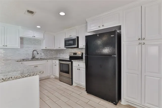 a kitchen with a refrigerator stove and microwave