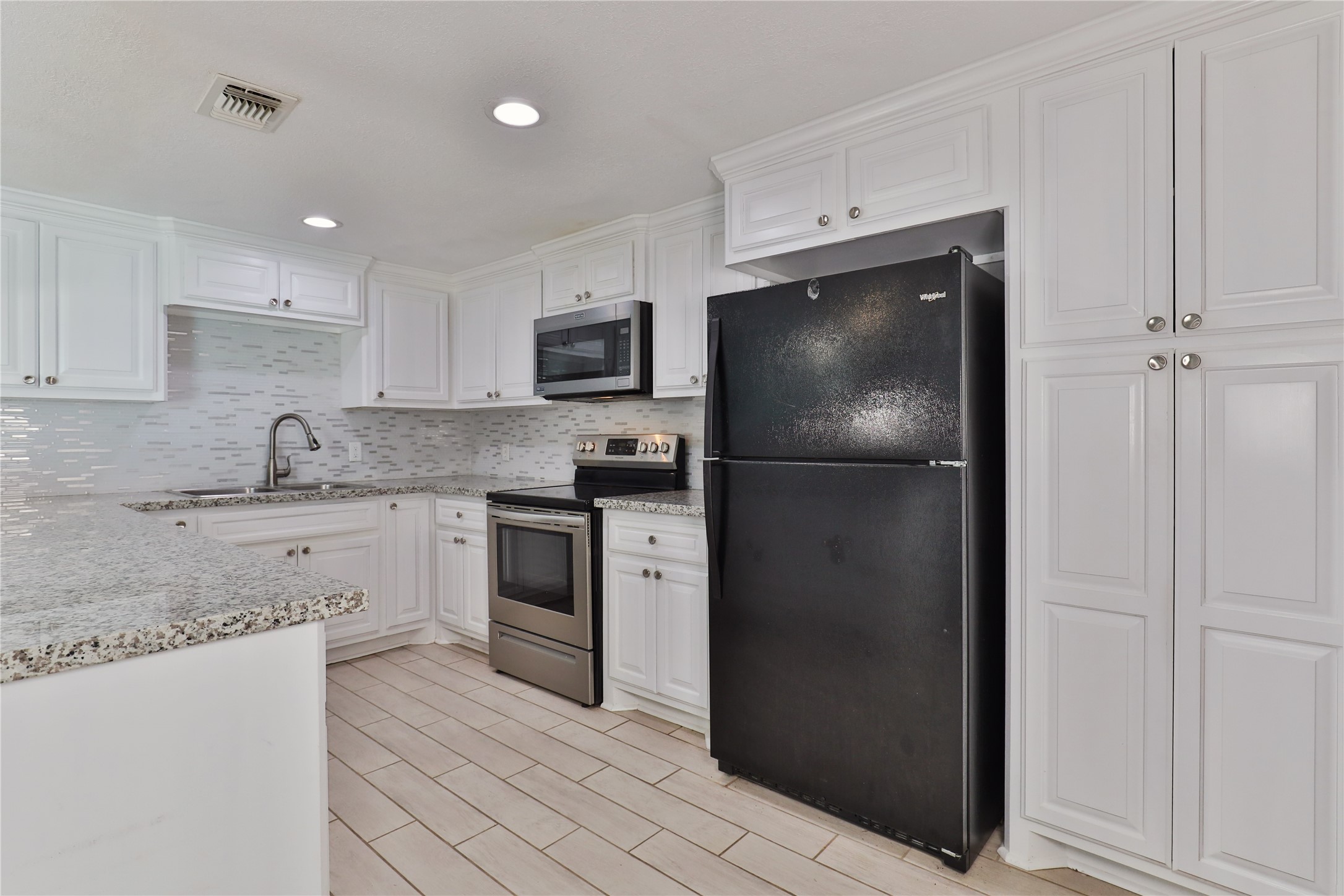 218 3 Rd Street Brazoria, TX 77422 - Photo 8 of 19 a kitchen with a refrigerator stove and microwave