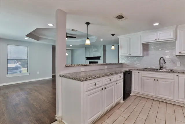 a kitchen with a sink stove and cabinets