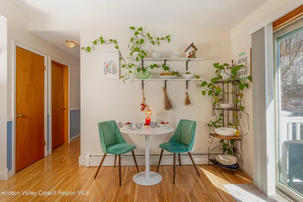 a view of a dining room with furniture window and wooden floor