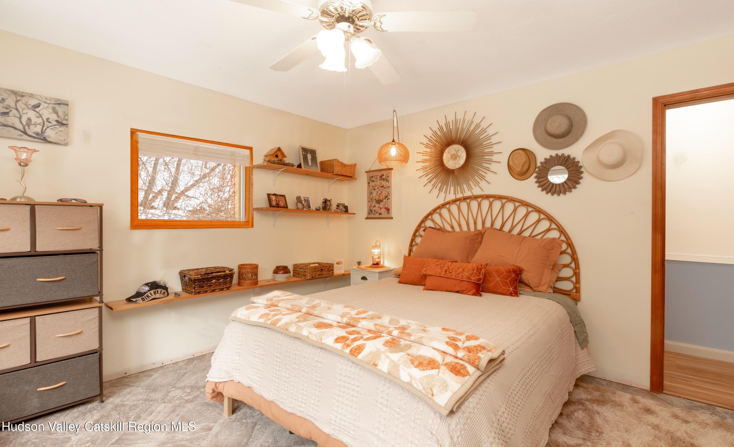 1046 Cow Hough Road New Paltz, NY 12561 - Photo 18 of 37 a bedroom with a bed and a chandelier