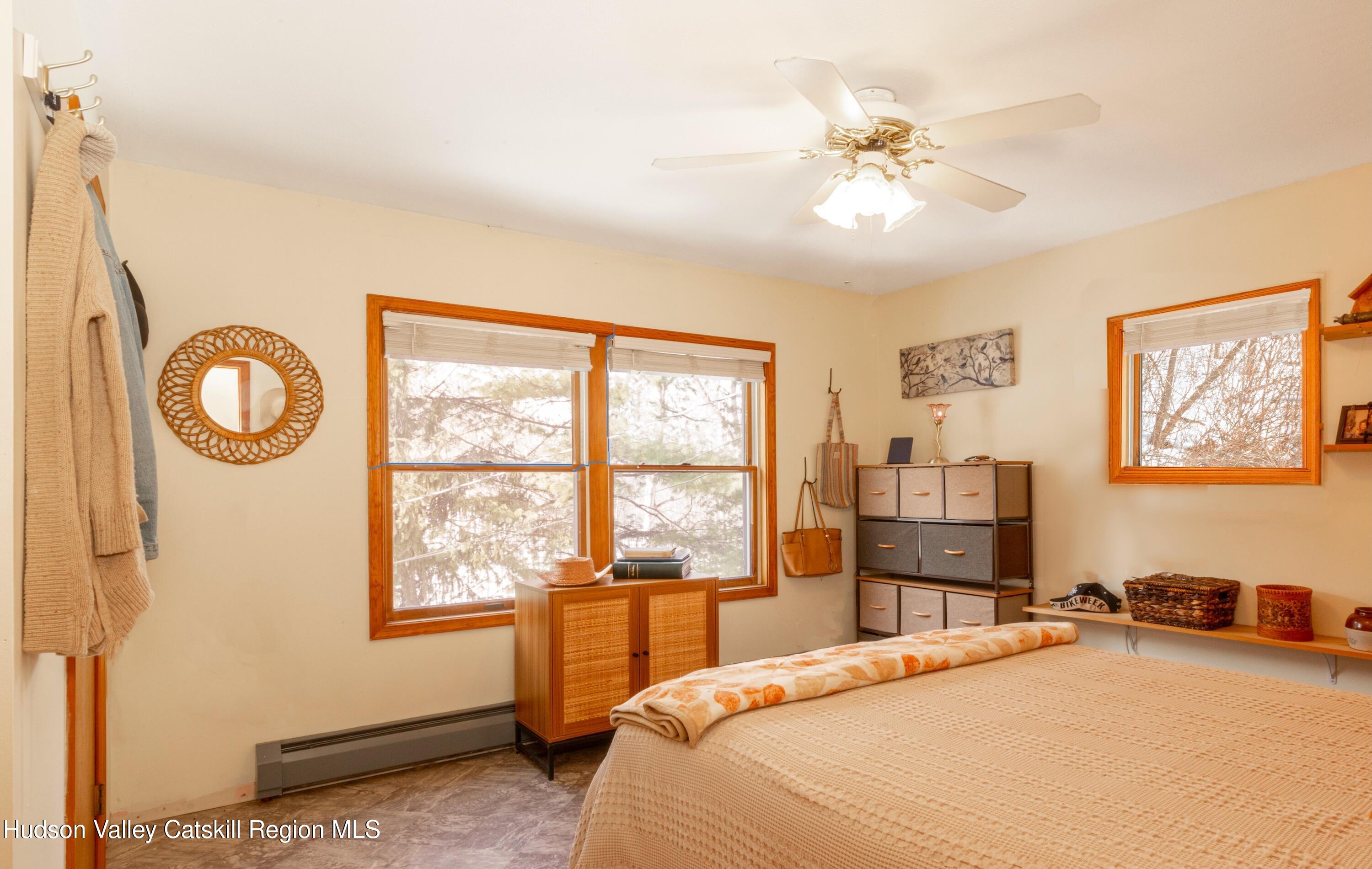 1046 Cow Hough Road New Paltz, NY 12561 - Photo 19 of 37 a bedroom with a bed and a chandelier