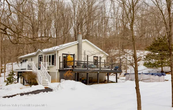 a view of a house with a yard covered in snow