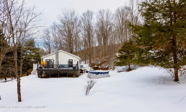 a view of a house with a yard covered in snow