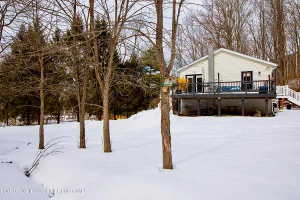 a view of a house with snow on the road