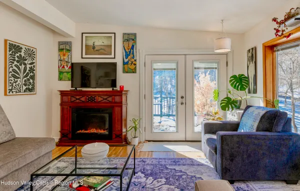 a living room with furniture a flat screen tv and a fireplace