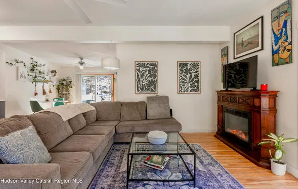 a living room with furniture a flat screen tv and a fireplace
