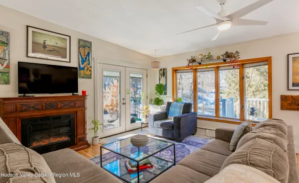 a living room with furniture a flat screen tv and a fireplace