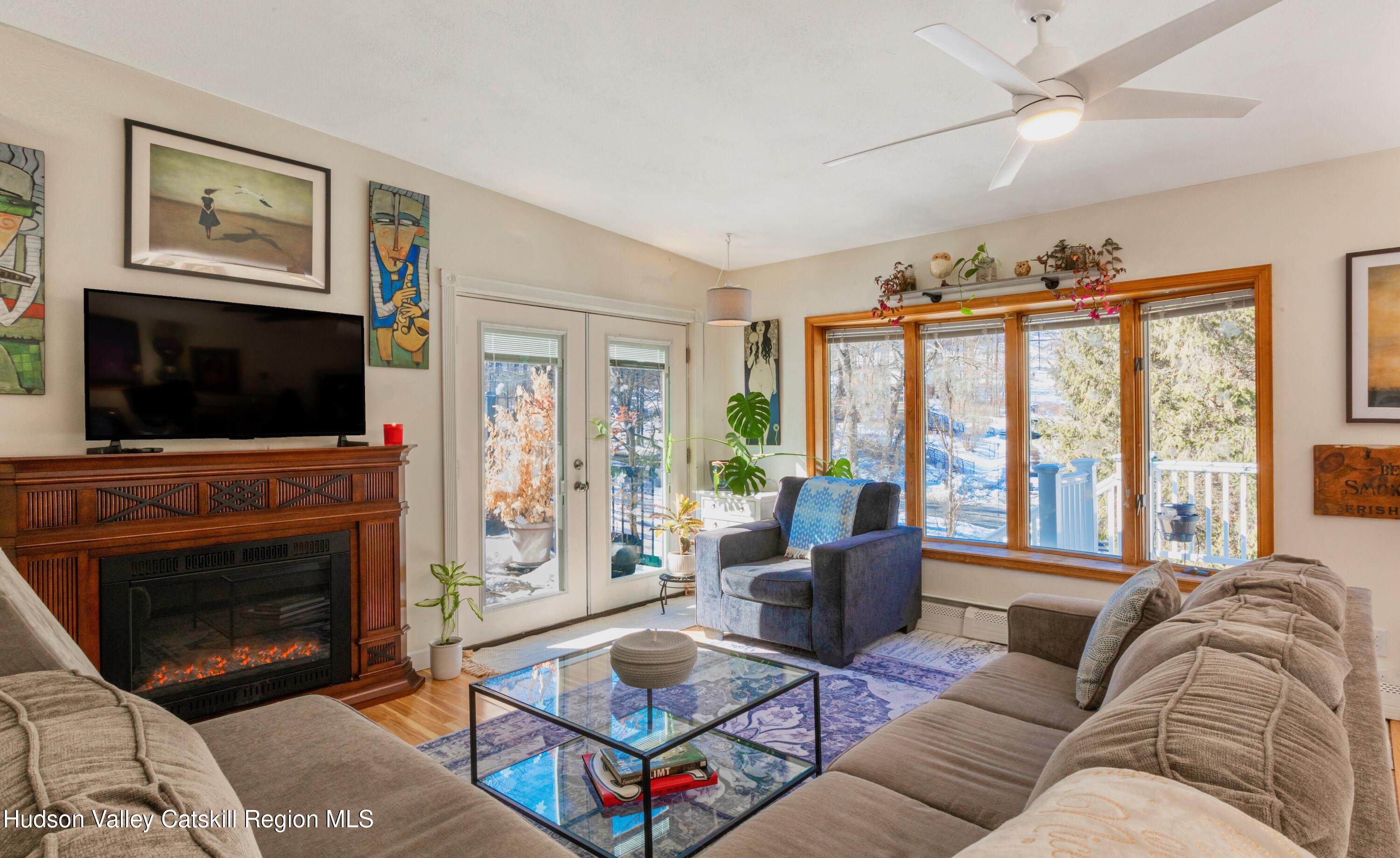 1046 Cow Hough Road New Paltz, NY 12561 - Photo 7 of 37 a living room with furniture a flat screen tv and a fireplace