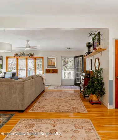 a large bed sitting in a bedroom next to a window and a flat screen tv