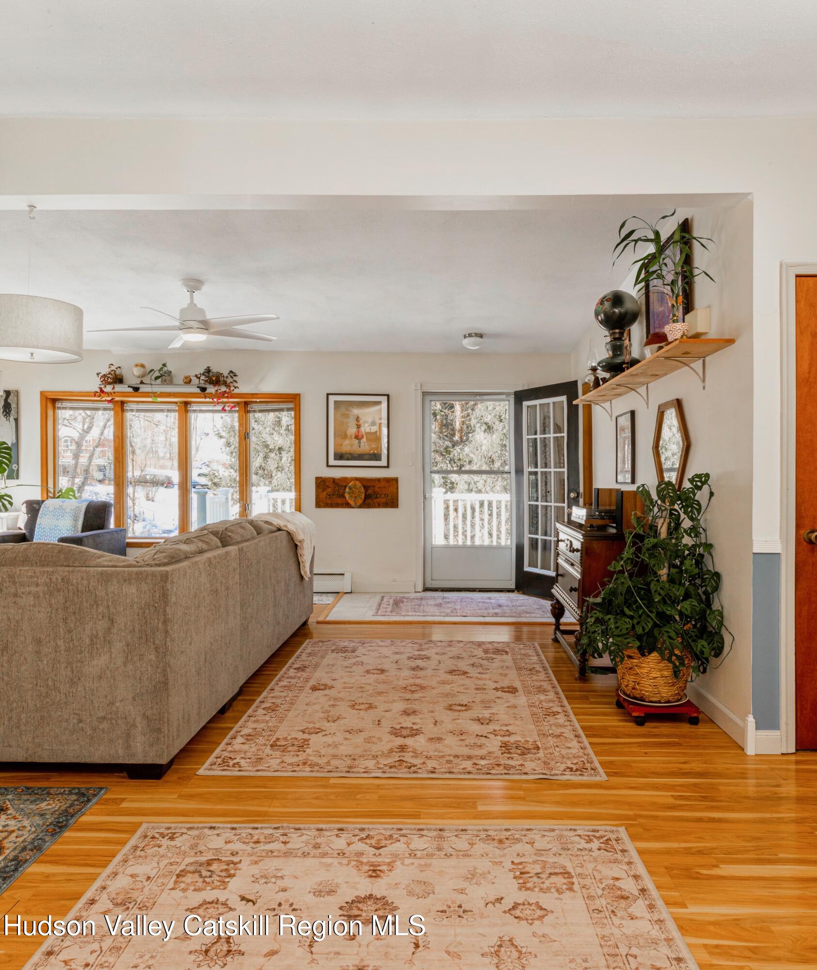 1046 Cow Hough Road New Paltz, NY 12561 - Photo 8 of 37 a large bed sitting in a bedroom next to a window and a flat screen tv