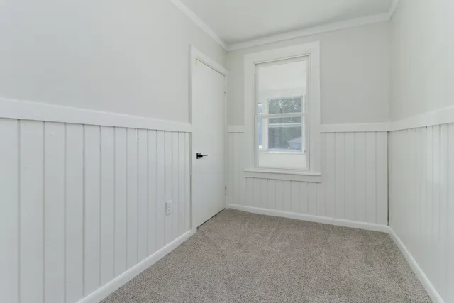 a living room with a black white checkered floor with next to a window