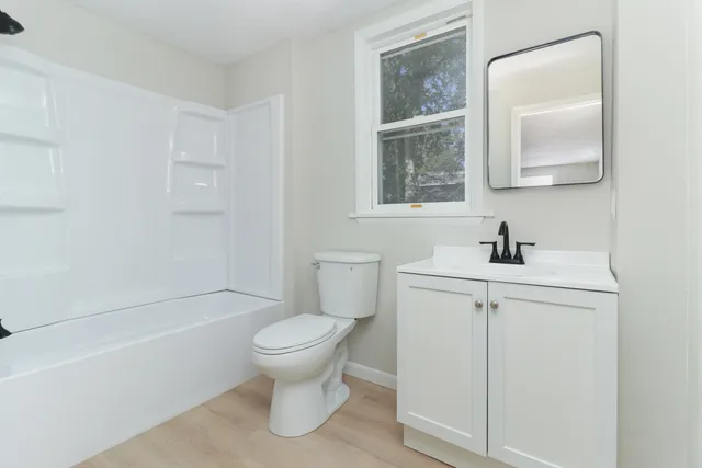 a bathroom with a sink toilet and vanity