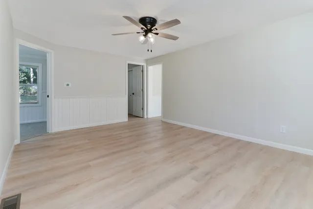 a view of a livingroom with a chandelier fan