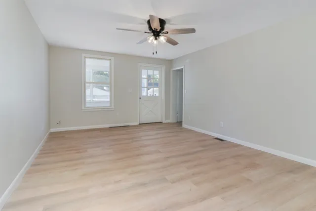 wooden floor in an empty room with a window