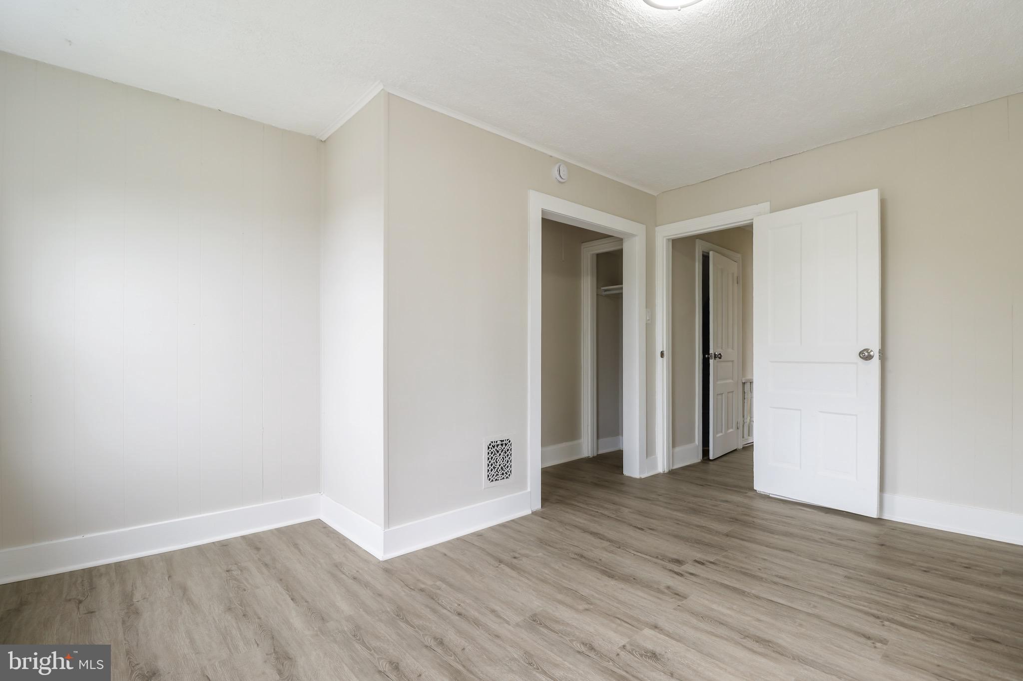 116 8th Street Salem, NJ 08079 - Photo 11 of 16 a view of an empty room with wooden floor and closet