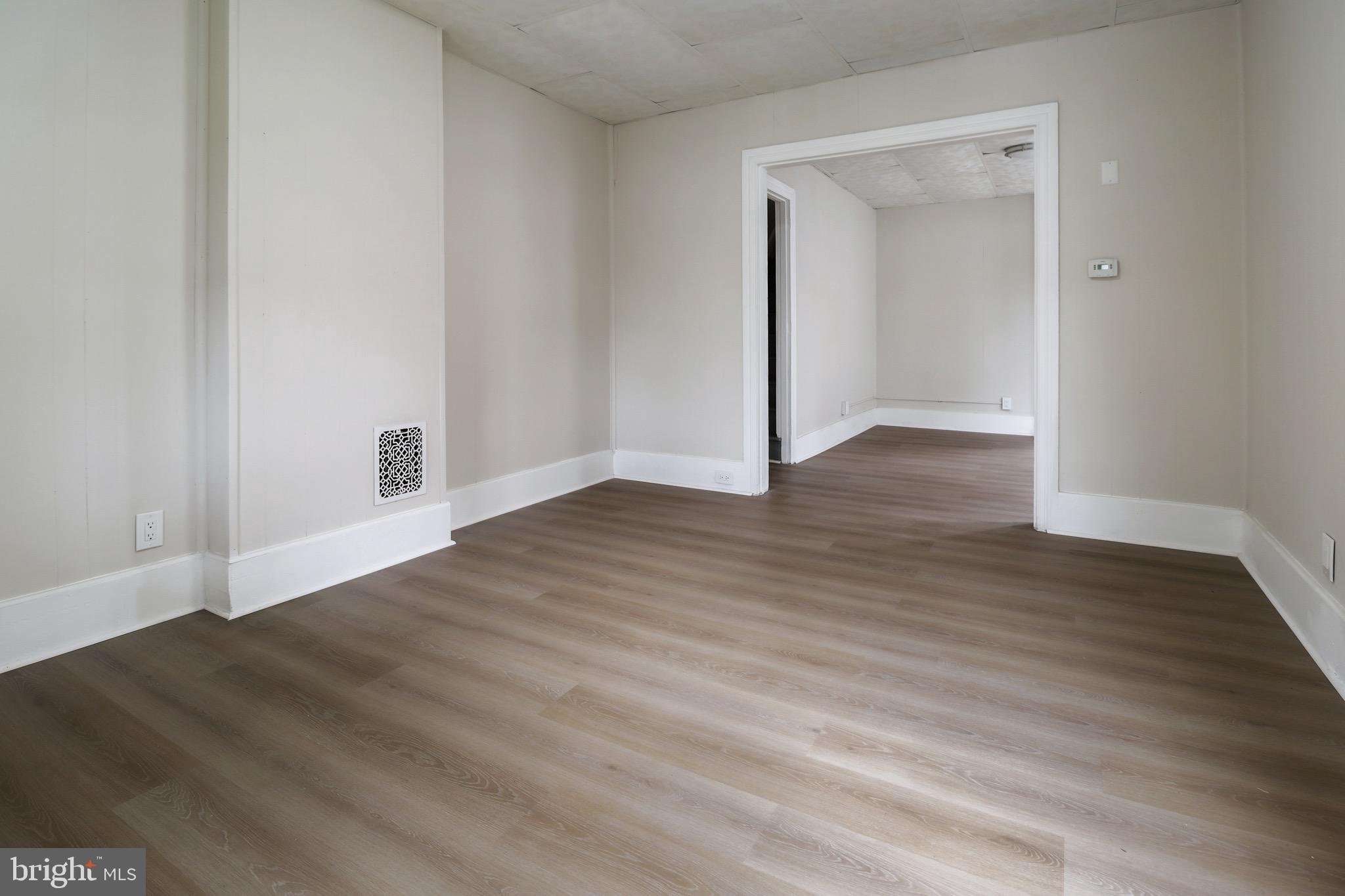 116 8th Street Salem, NJ 08079 - Photo 2 of 16 a view of an empty room and wooden floor