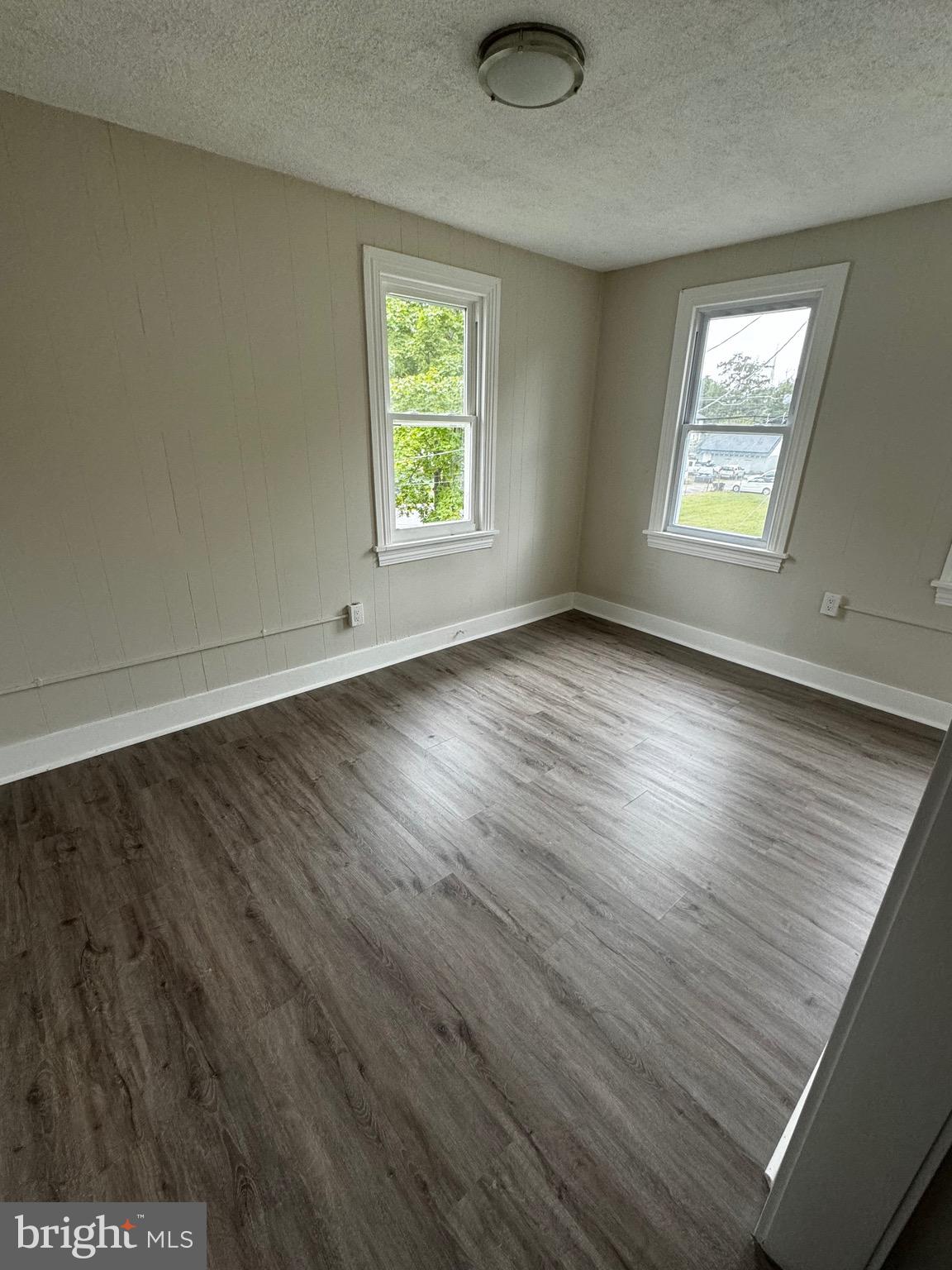 116 8th Street Salem, NJ 08079 - Photo 9 of 16 an empty room with wooden floor and windows