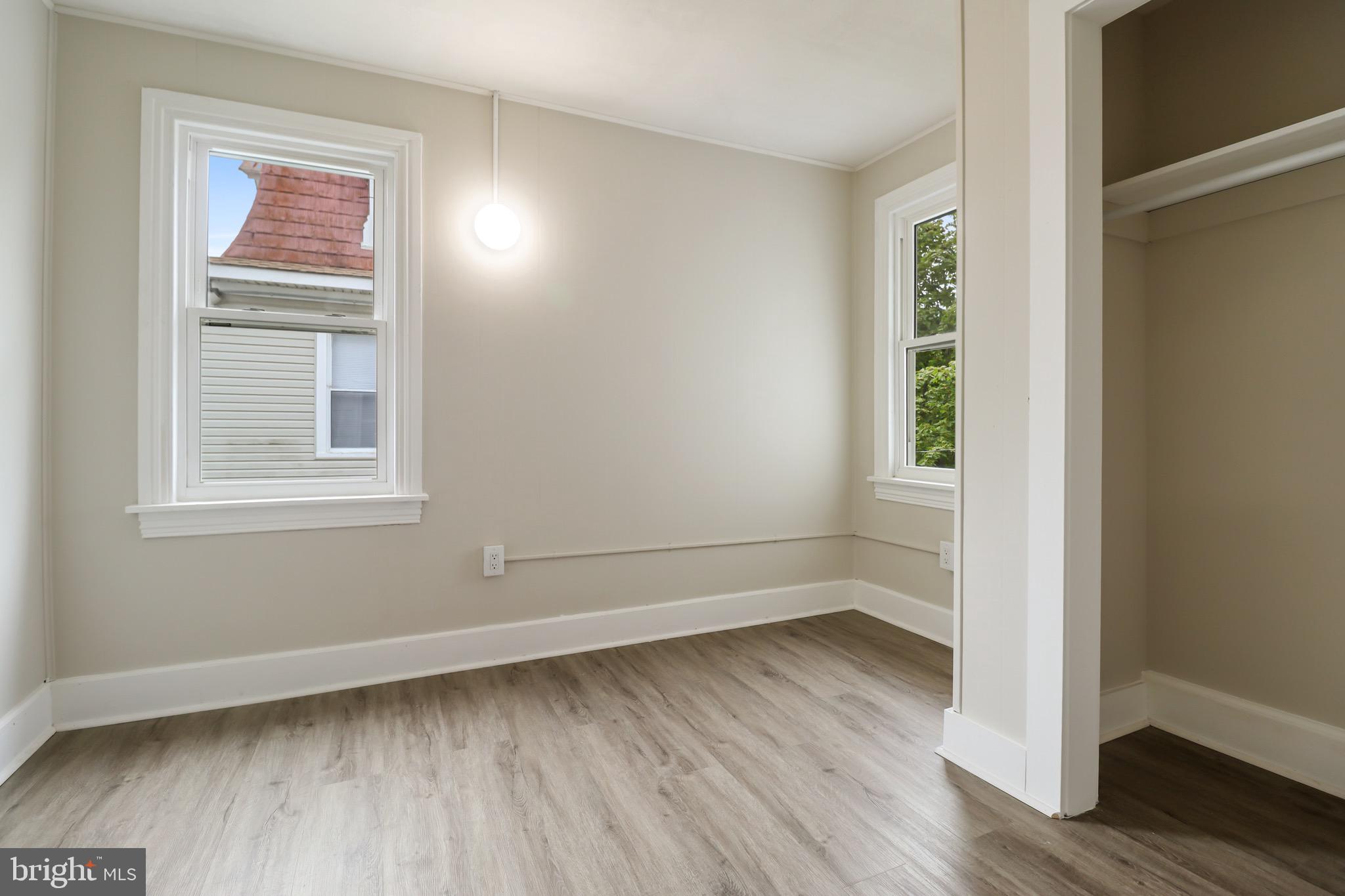 116 8th Street Salem, NJ 08079 - Photo 10 of 16 an empty room with wooden floor and windows