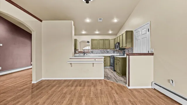 a kitchen with stainless steel appliances granite countertop a sink and cabinets