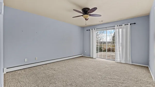 a view of a room with a ceiling fan