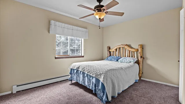 a bedroom with a bed and a window