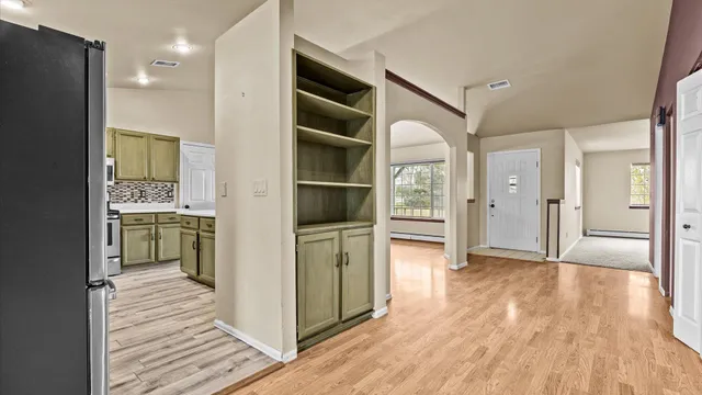 a view of a kitchen with wooden floor and a kitchen