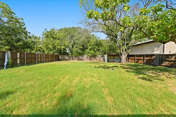 a front view of a house with yard and green space