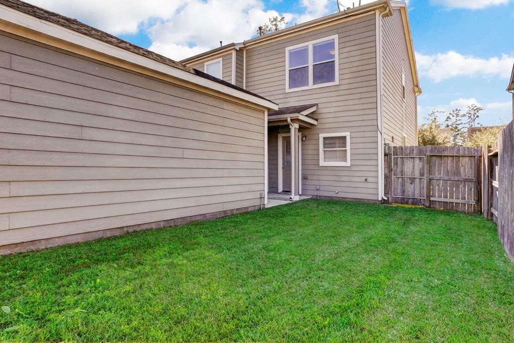 23830 Single Oak Street Spring, TX 77373 - Photo 10 of 10 a view of a backyard with wooden fence
