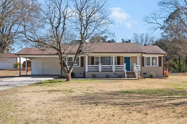 a front view of a house with yard patio and fire pit
