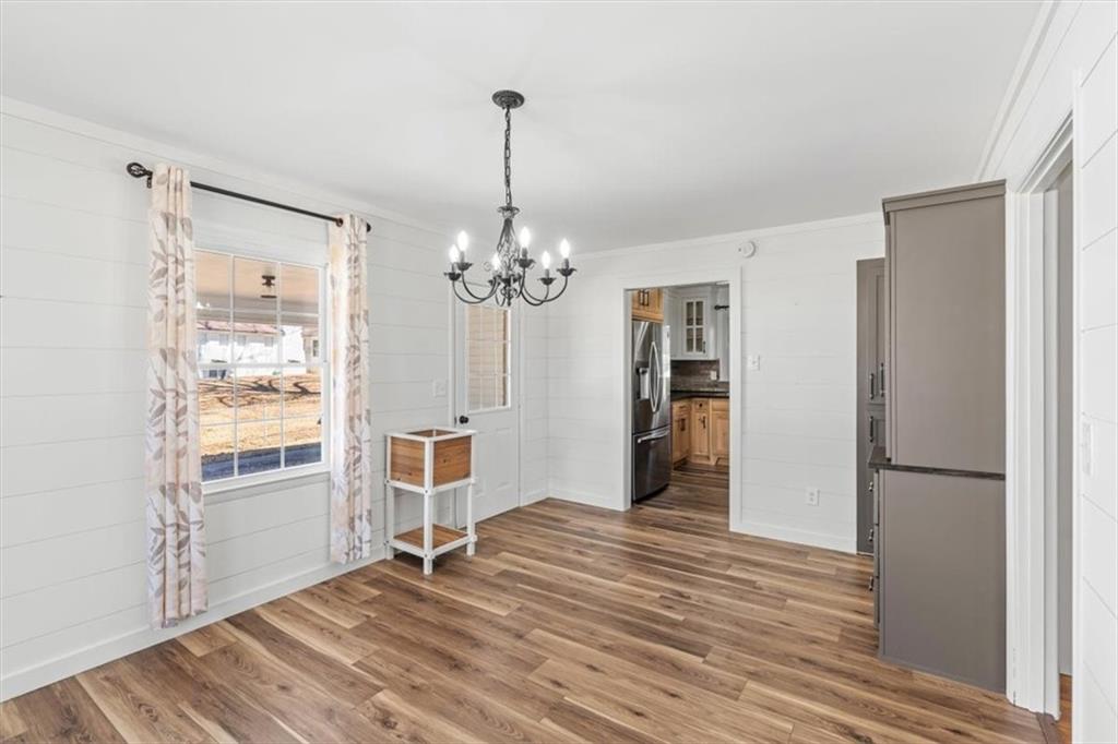 240 John Phillips Road Cedartown, GA 30125 - Photo 11 of 55 a view of a livingroom with wooden floor staircase and a kitchen space