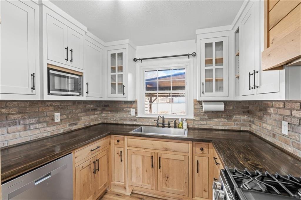 240 John Phillips Road Cedartown, GA 30125 - Photo 15 of 55 a kitchen with stainless steel appliances granite countertop white cabinets sink and window