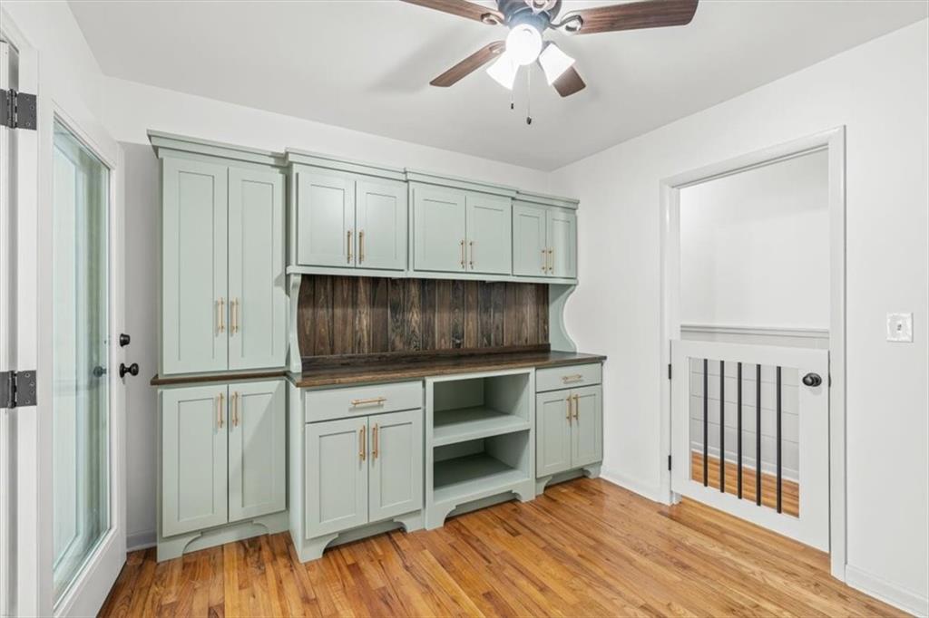 240 John Phillips Road Cedartown, GA 30125 - Photo 27 of 55 a kitchen with stainless steel appliances white cabinets and wooden floors