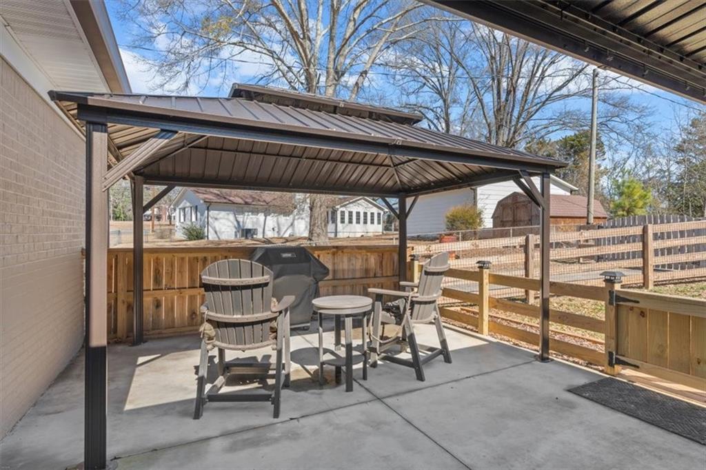 240 John Phillips Road Cedartown, GA 30125 - Photo 33 of 55 a view of a chairs and table in the patio
