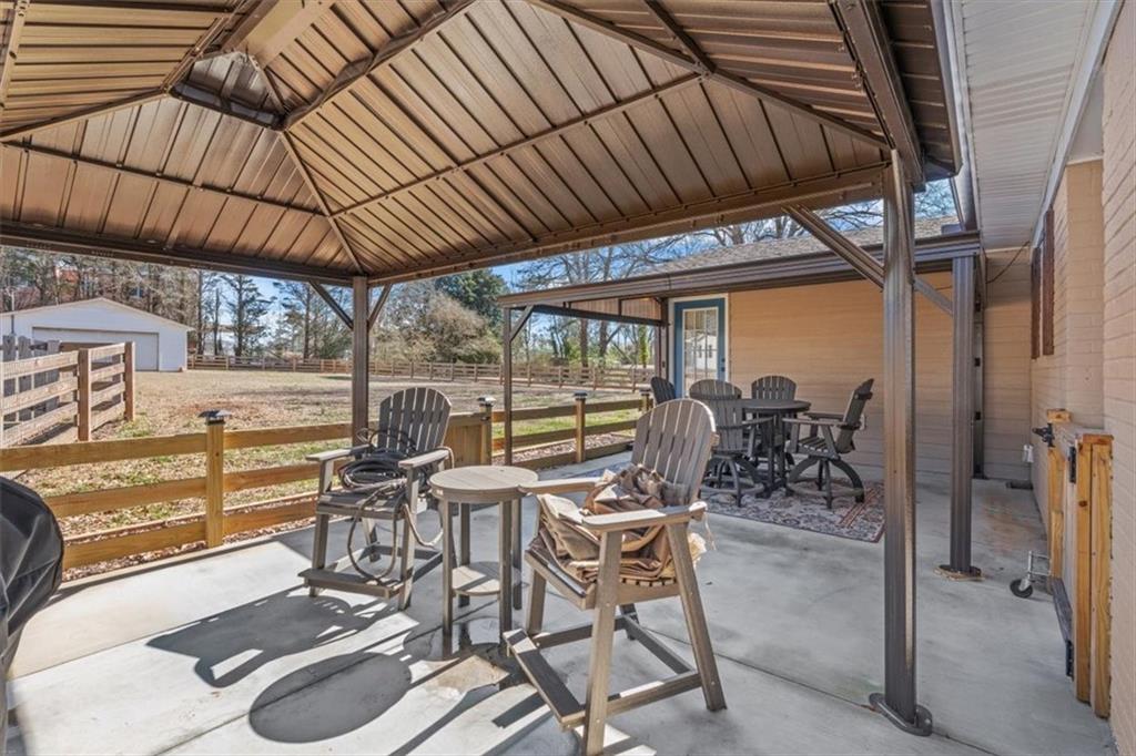 240 John Phillips Road Cedartown, GA 30125 - Photo 34 of 55 a view of a patio with table and chairs and potted plants
